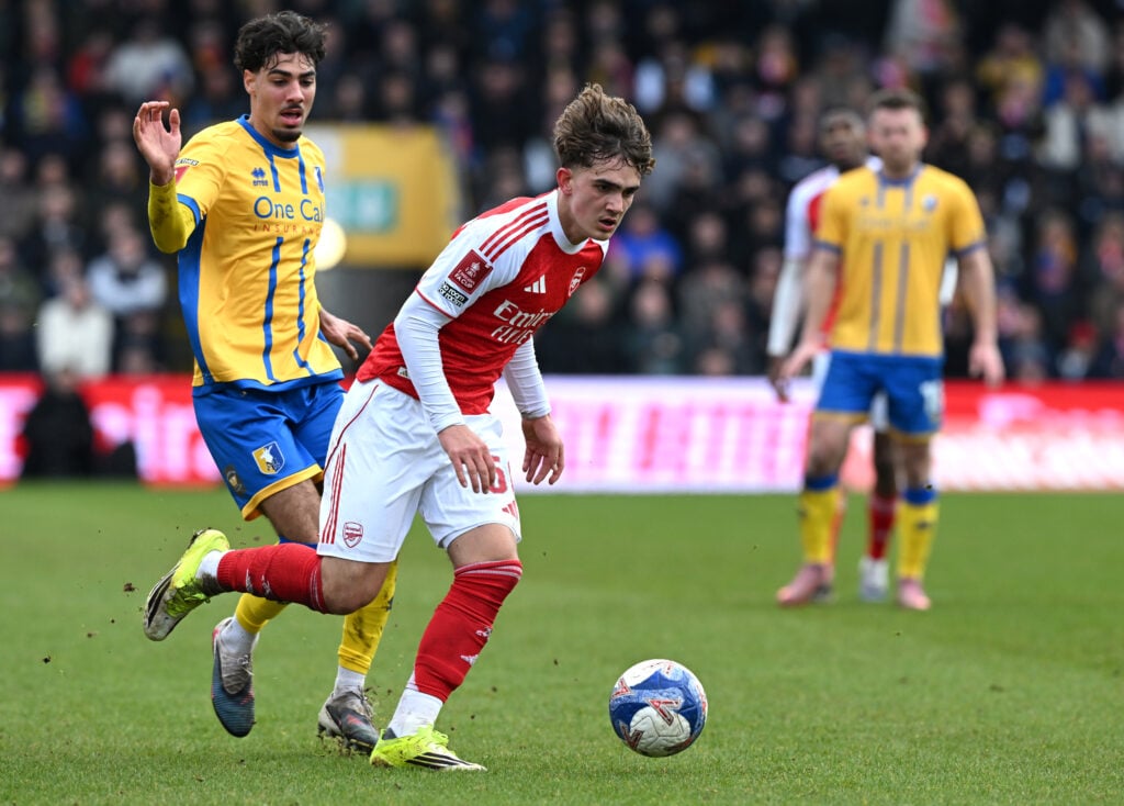 Max Dowman runs with the ball during Mansfield Town vs Arsenal