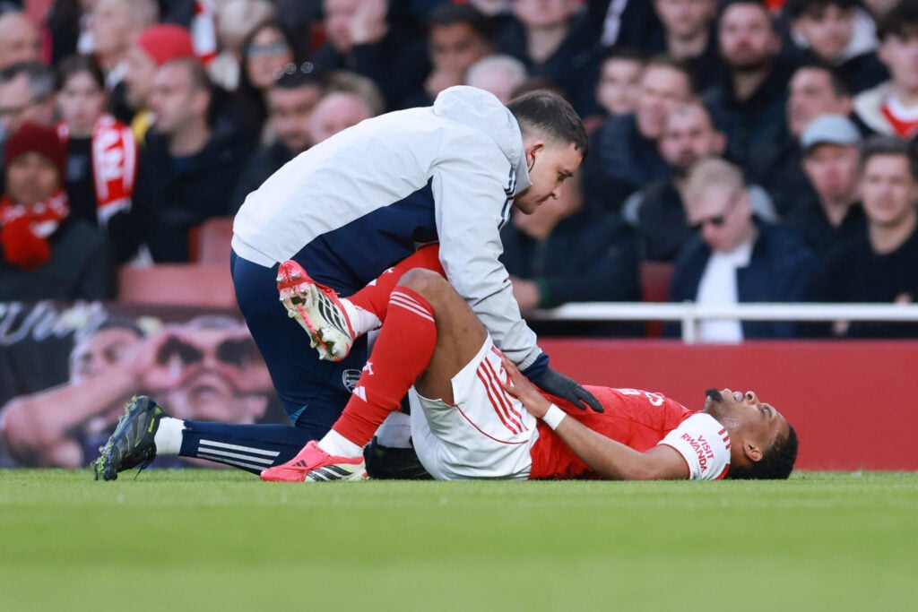 Jurrien Timber of Arsenal is treated for an injury during the Premier League match between Arsenal and Everton at Emirates Stadium.