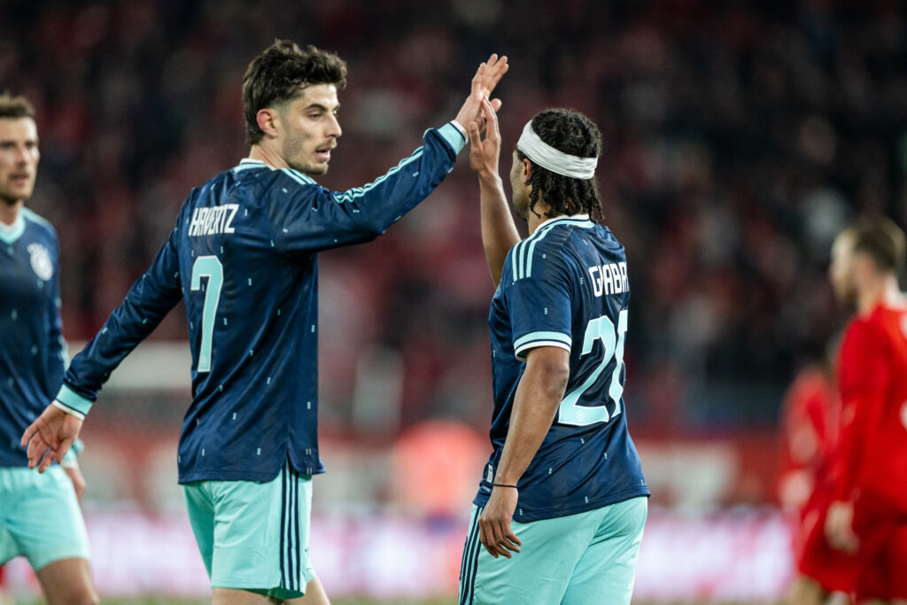 Kai Havertz high-fives Serge Gnabry during a Germany game