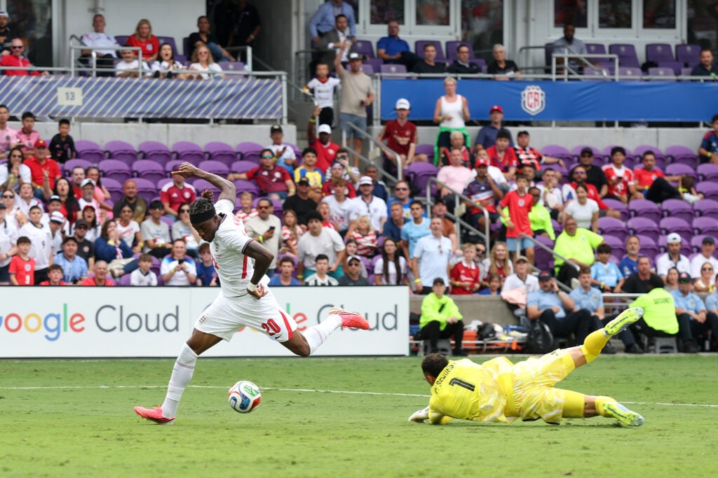 Noni Madueke rounds the goalkeeper and is about to get his shot off during an England game