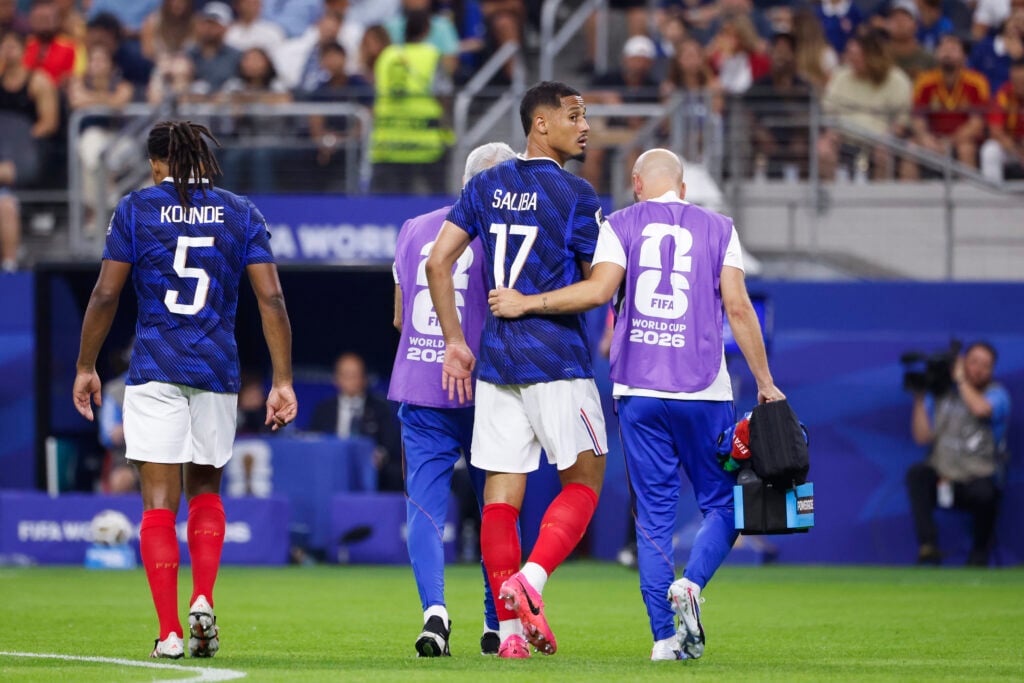 William Saliba helped off the pitch after suffering an injury during France vs Spain at the 2026 World Cup